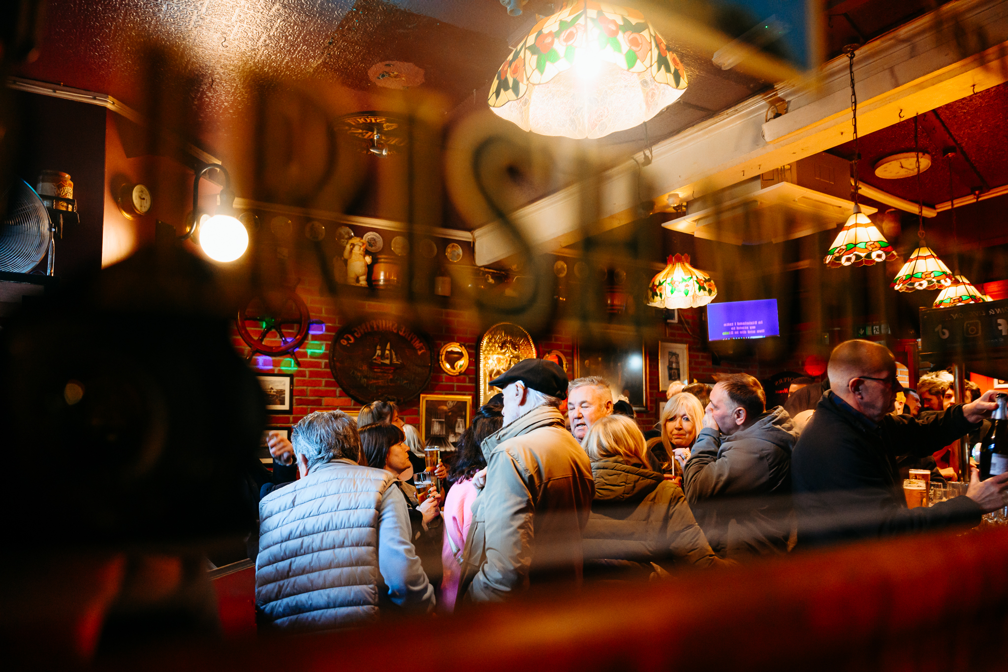 Looking through window of Cooper pub at patrons